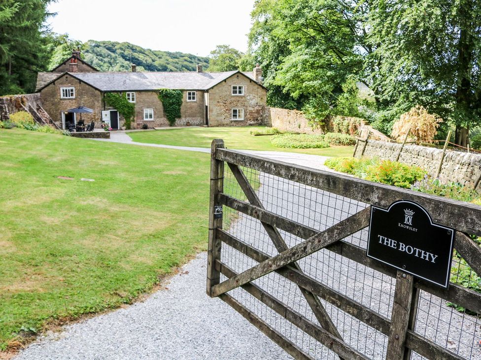 An outdoor view of The Bothy with a gate and grassy area at The Bothy in Wildboarclough