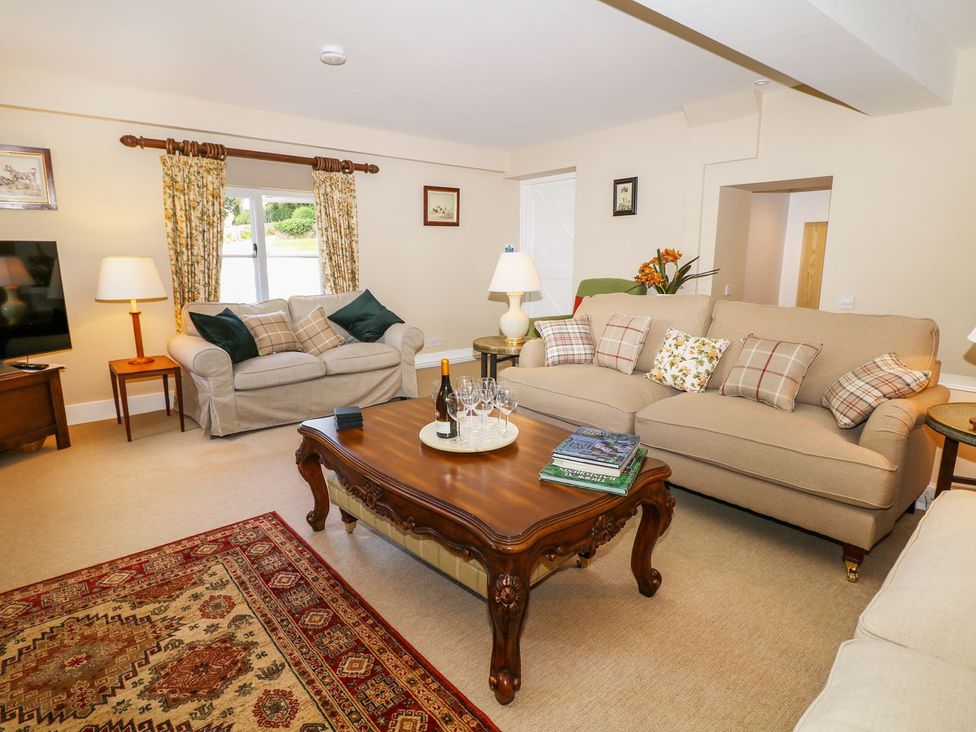 A living room with sofas and a coffee table at The Bothy in Wildboarclough
