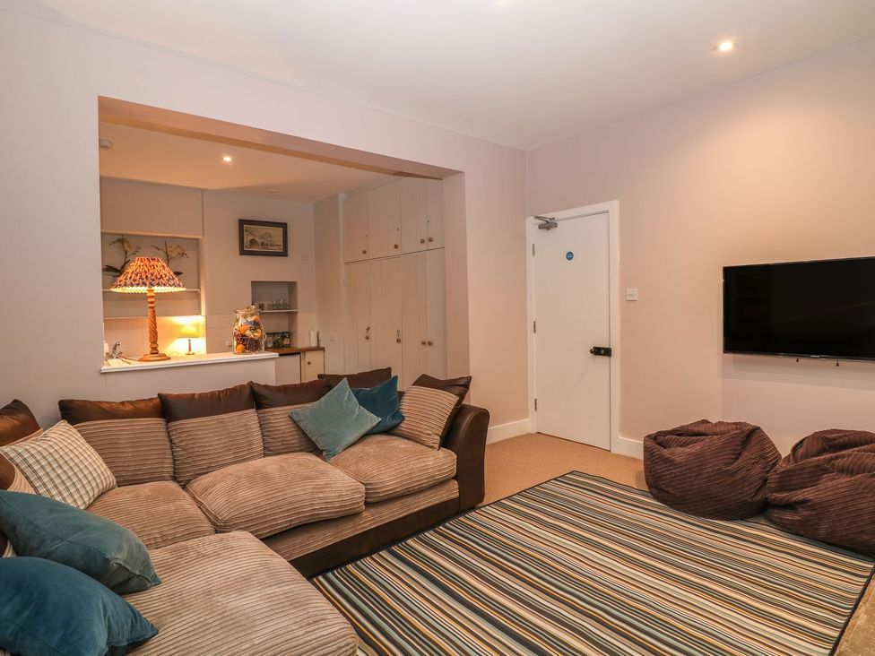A living room with a sofa and television at The Bothy in Wildboarclough