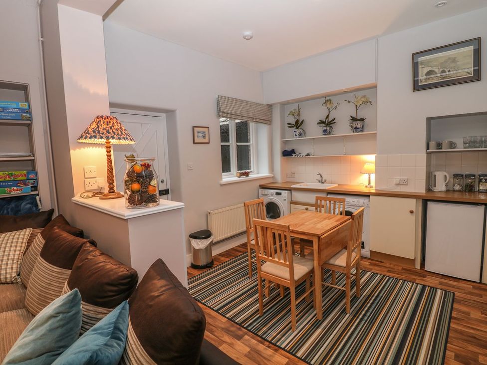 A kitchen with a dining table and chairs at The Bothy in Wildboarclough