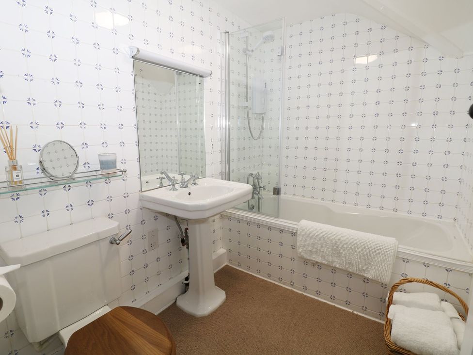 A bathroom with a sink, bathtub, and toilet at The Bothy in Wildboarclough
