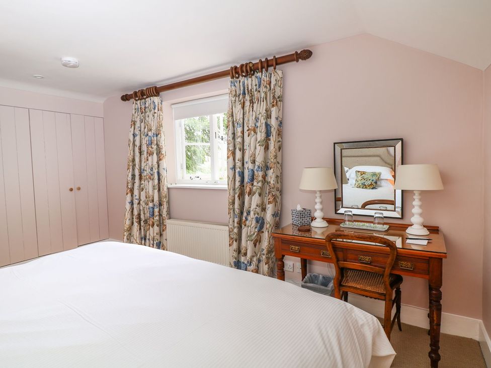 A bedroom with a desk and chair at The Bothy in Wildboarclough
