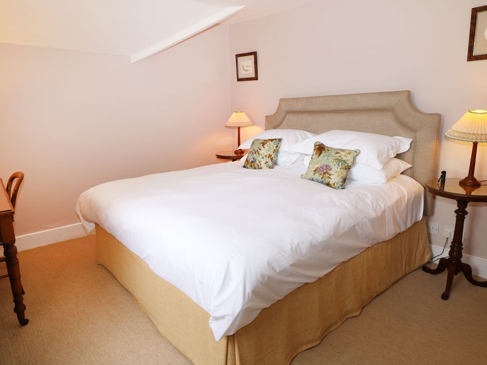 A bedroom with a bed and bedside tables at The Bothy in Wildboarclough
