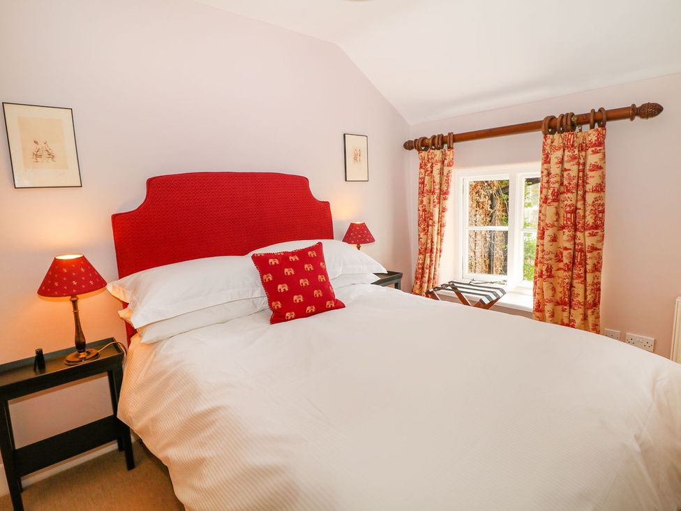 A bedroom with a bed and window at The Bothy in Wildboarclough