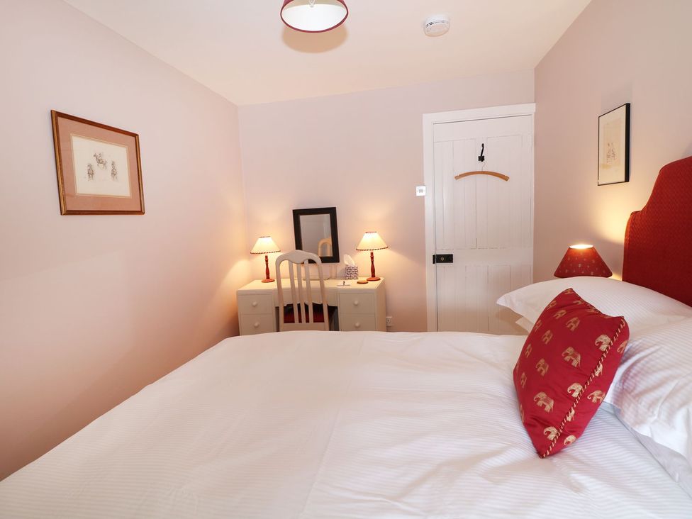 A bedroom with a bed and desk at The Bothy in Wildboarclough
