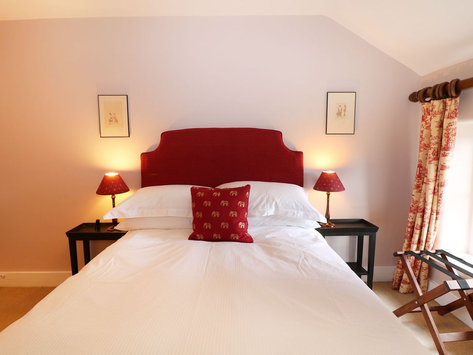A bedroom with a bed and bedside tables at The Bothy in Wildboarclough