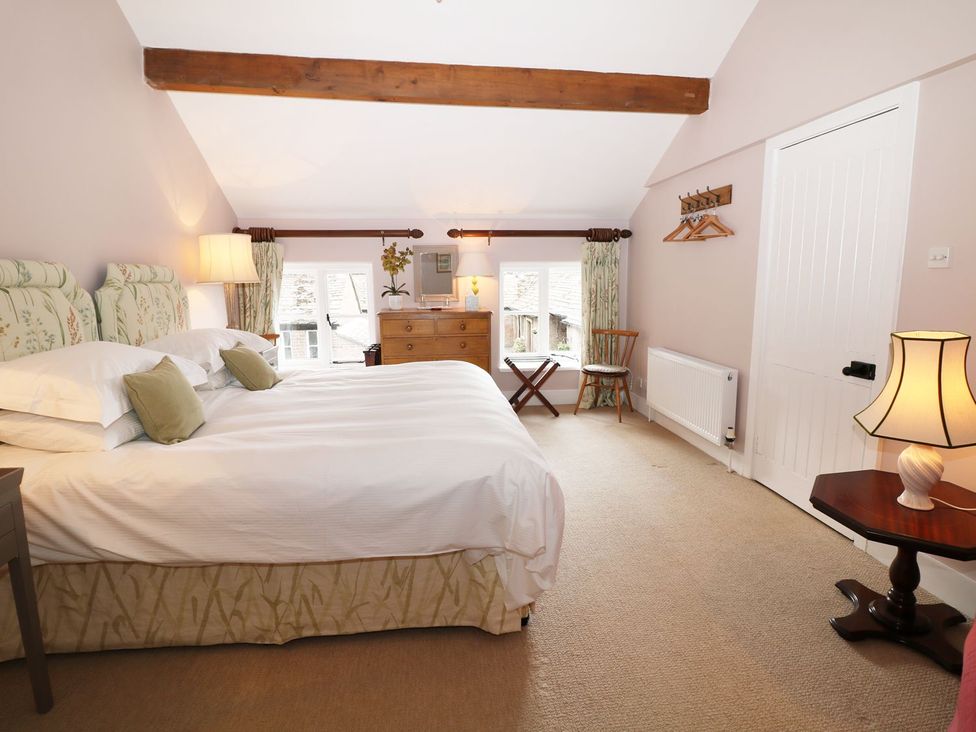A bedroom with a bed and dresser at The Bothy in Wildboarclough
