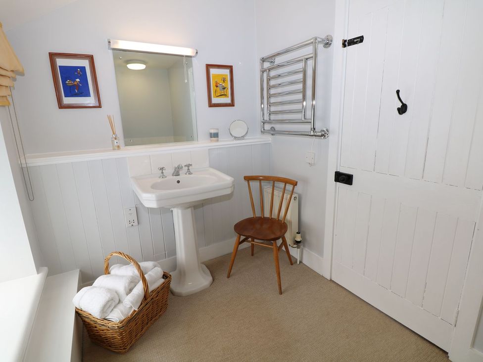 A bathroom with a sink and a mirror at The Bothy in Wildboarclough