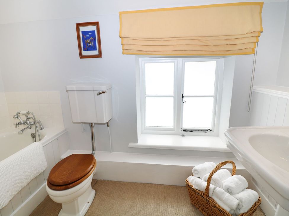 A bathroom with a bathtub and toilet at The Bothy in Wildboarclough