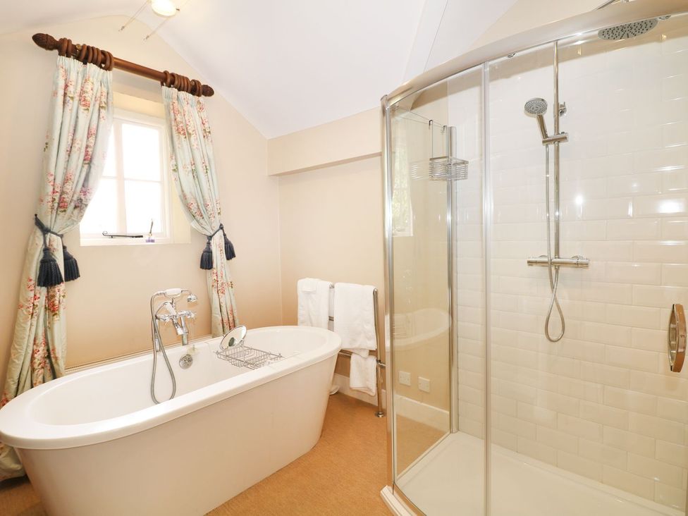 A bathroom with a bathtub and shower at The Bothy in Wildboarclough