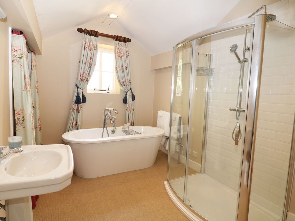 A bathroom with a bathtub and shower at The Bothy in Wildboarclough