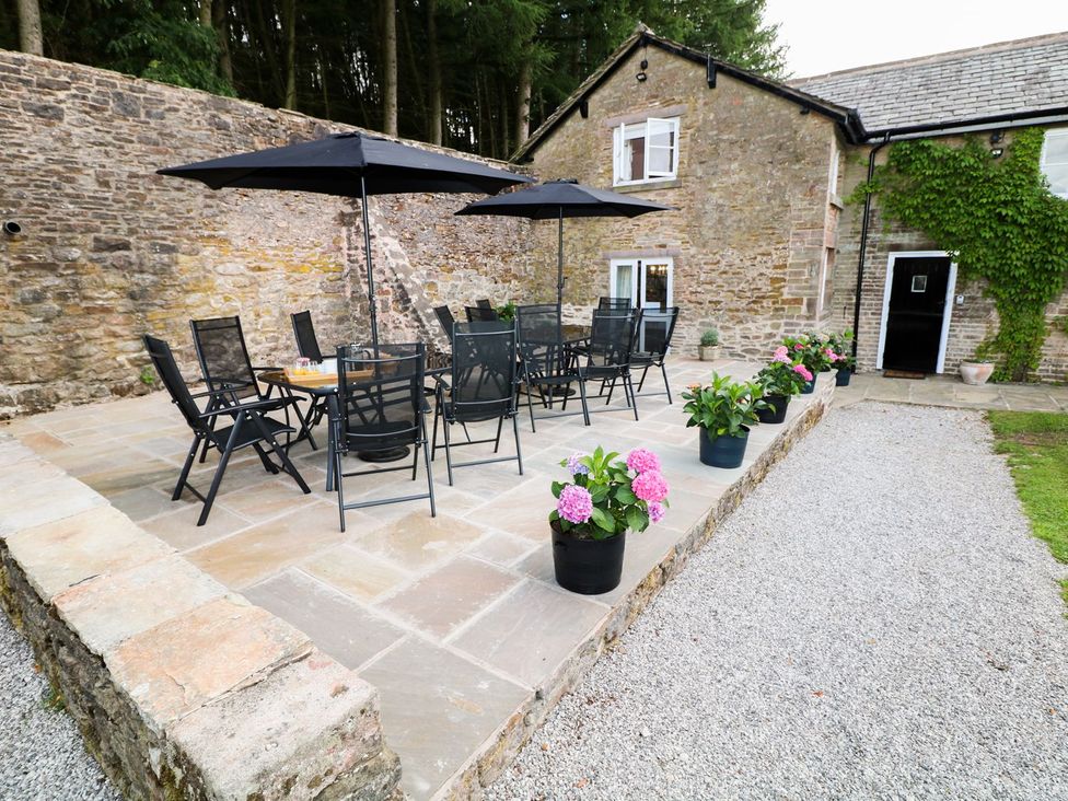 An outdoor patio with a table and chairs at The Bothy Wildboarclough