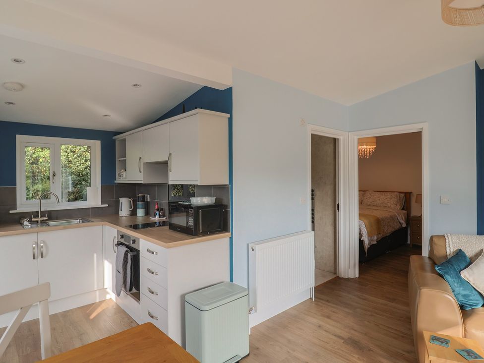 A kitchen with a sink and stove at The Roost in Whitford Nr. Colyton