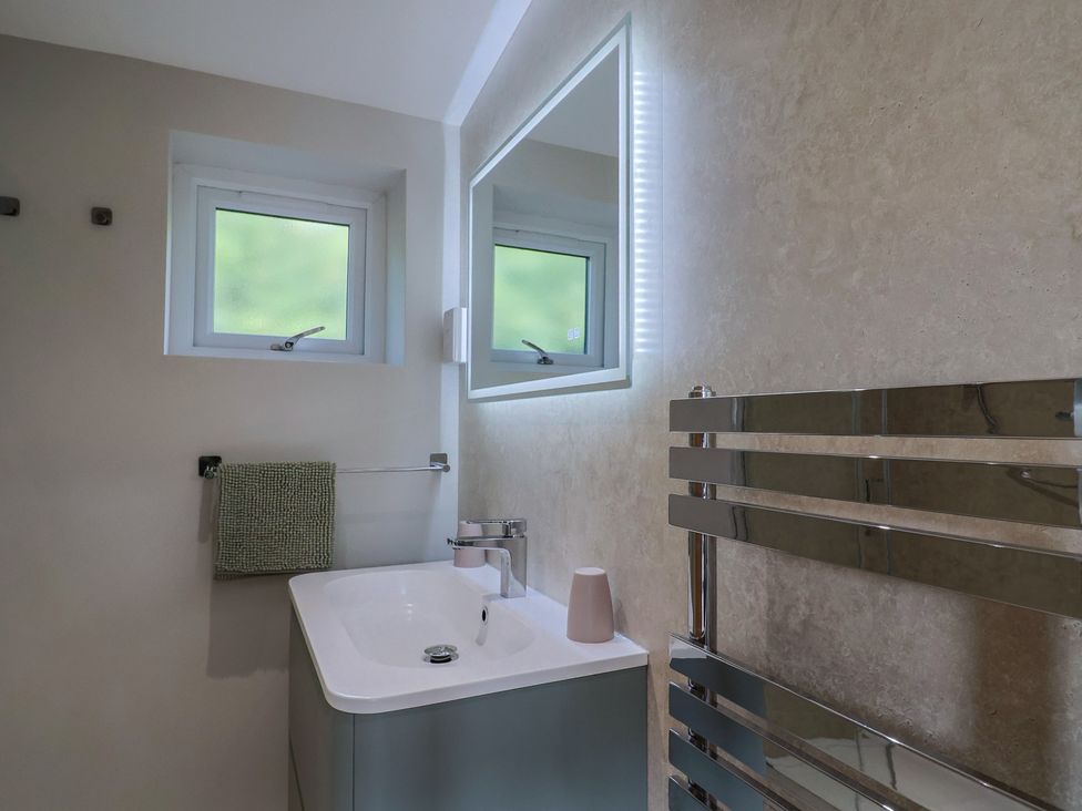 A bathroom with a sink and mirror at The Roost in Whitford Nr. Colyton
