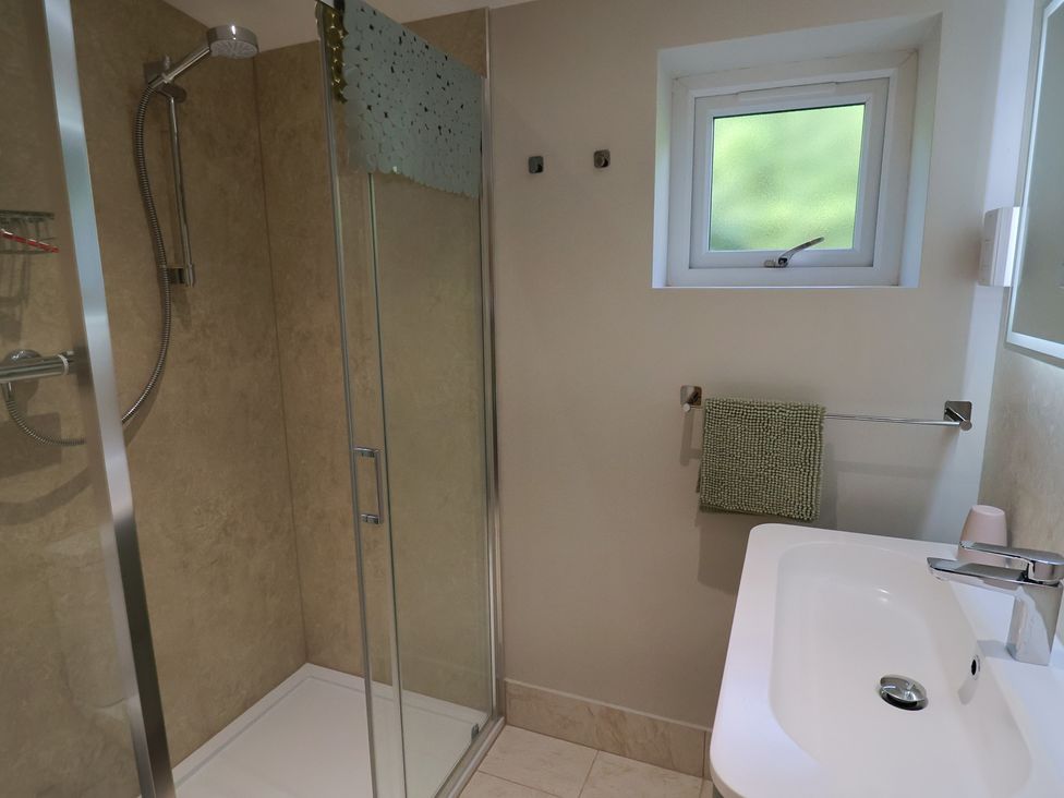 A bathroom with a shower and sink at The Roost in Whitford Nr. Colyton