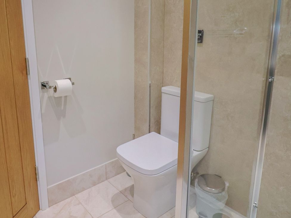 A bathroom with toilet and shower at The Roost in Whitford Nr. Colyton