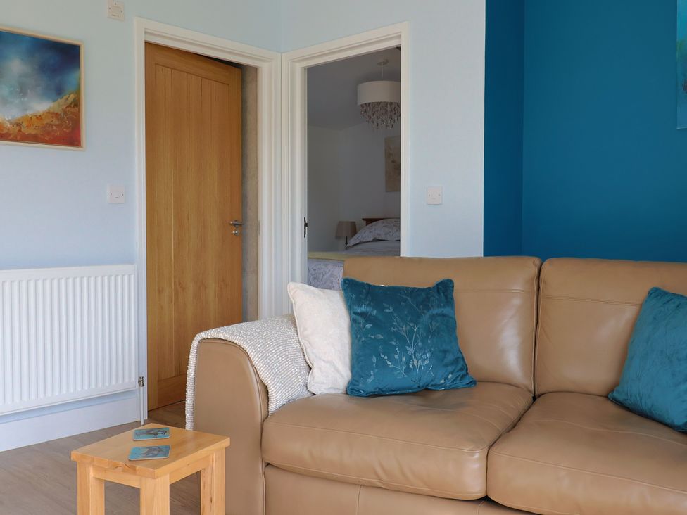 A living room with a sofa and coffee table at The Roost in Whitford Nr. Colyton