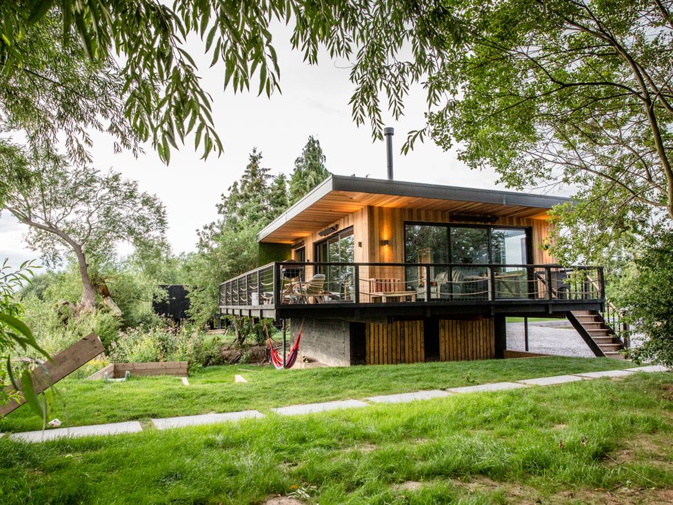 A house with a deck and hammock in the outdoor area at The Red House Farndon