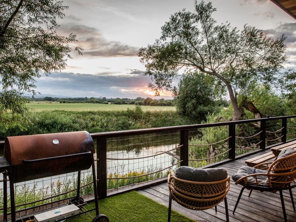 An outdoor area with a barbecue grill and chairs at The Red House in Farndon