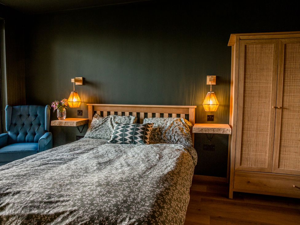A bedroom with a bed and bedside tables at The Red House in Farndon