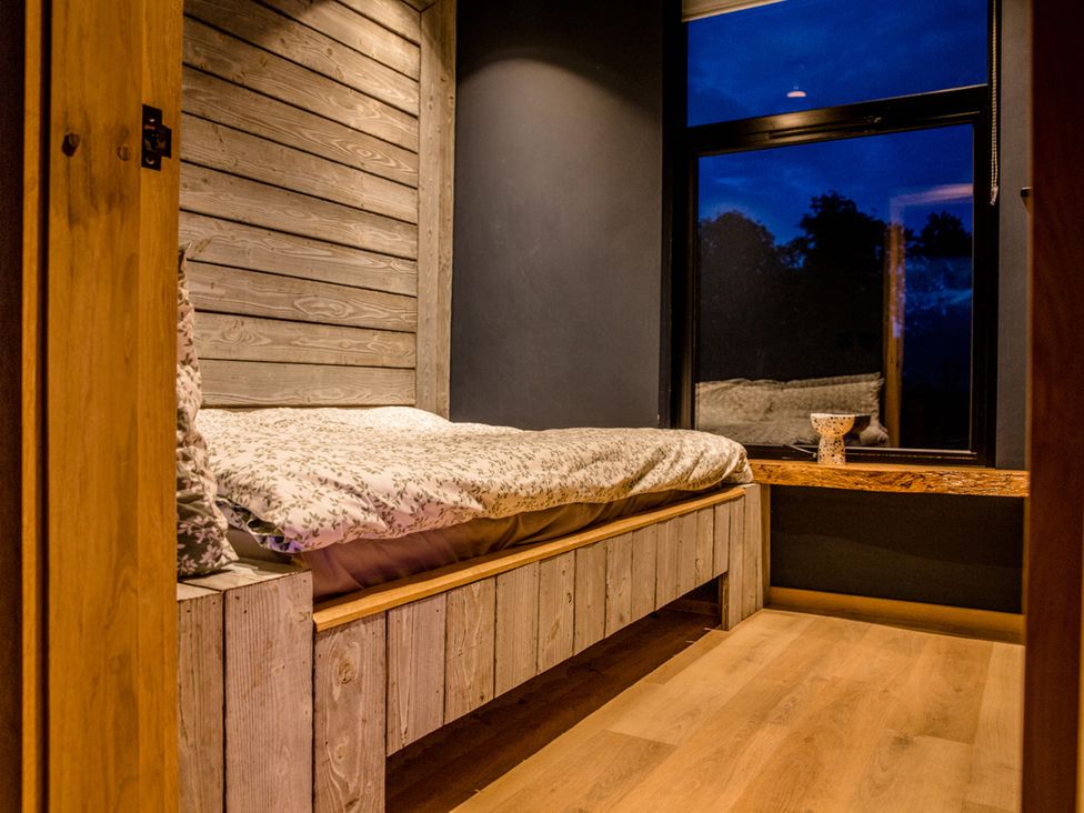 A bedroom with a bed and window at The Red House in Farndon