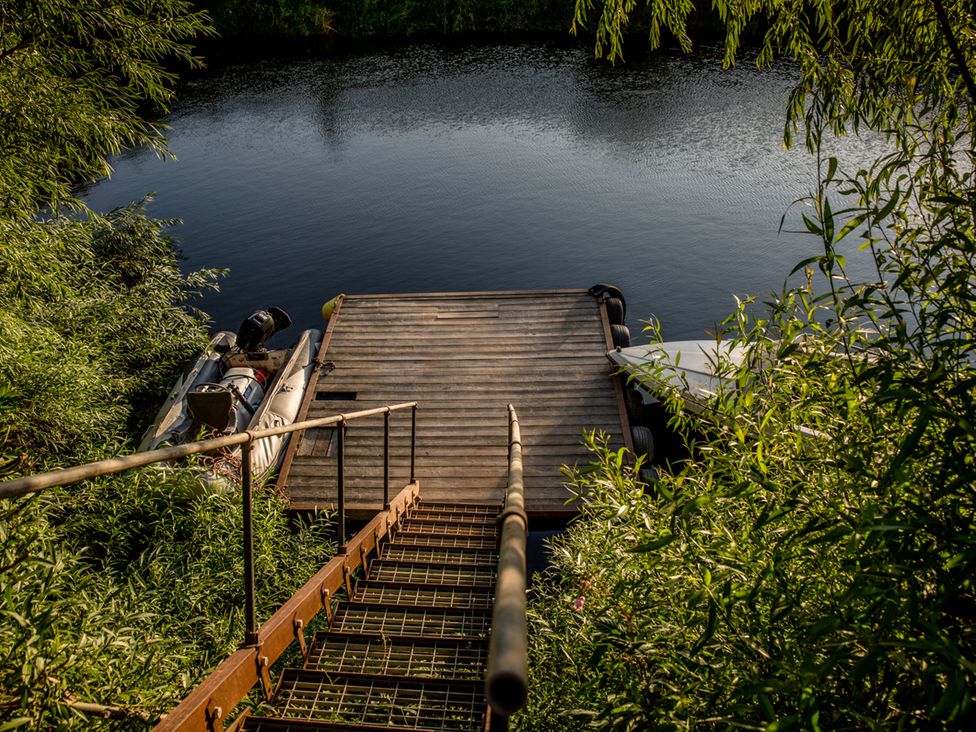 Steps leading down to a dock by the water at The Red House Farndon