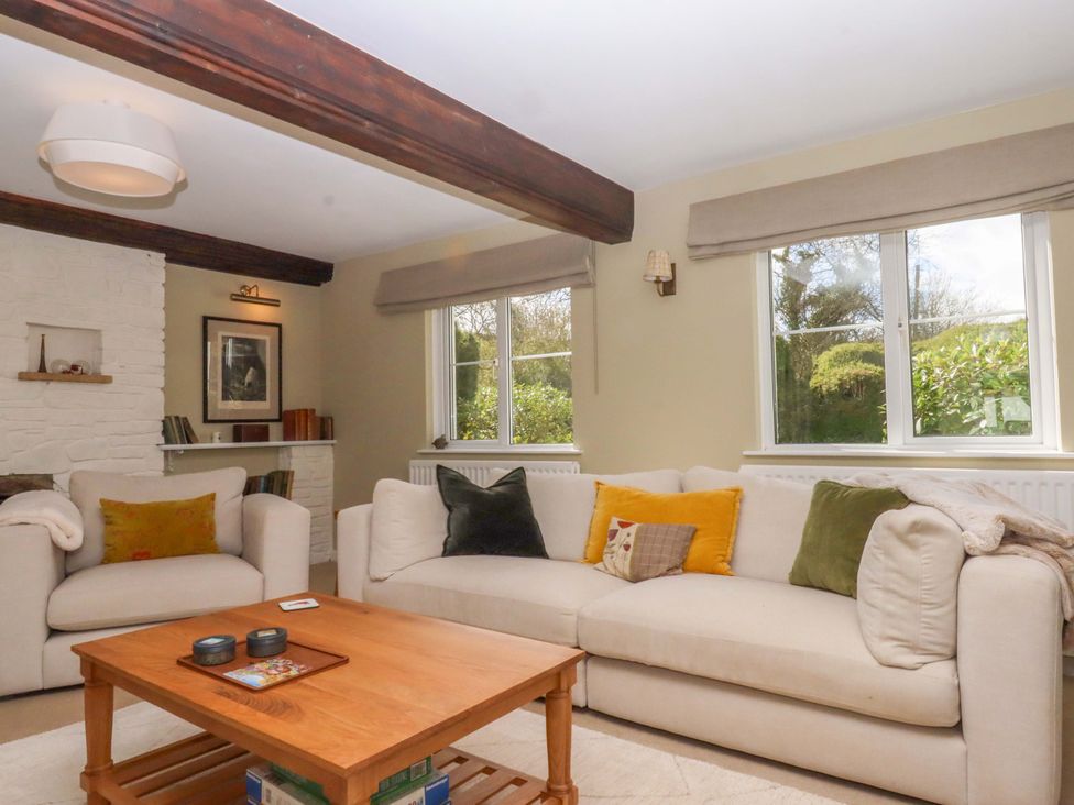 A living room with a sofa and coffee table at Town Farm Cottage Barnstaple