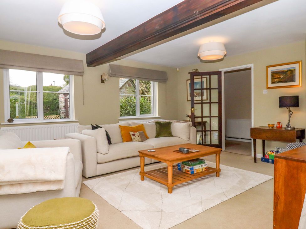 A living room with a sofa and coffee table at Town Farm Cottage Barnstaple