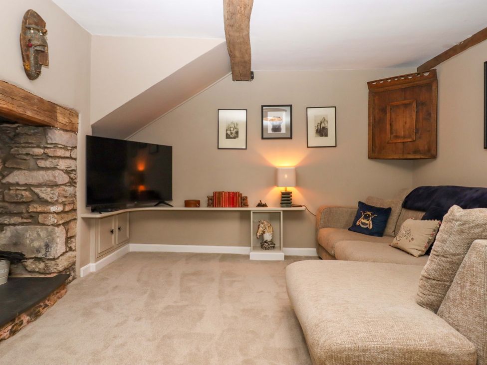 A living room with television and sofa at Town Farm Cottage Barnstaple