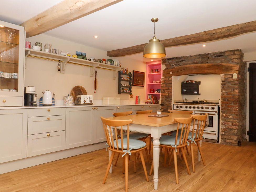A kitchen with a table and chairs at Town Farm Cottage Barnstaple