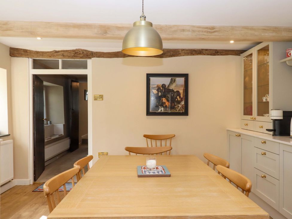 A kitchen with a wooden table and chairs at Town Farm Cottage in Barnstaple