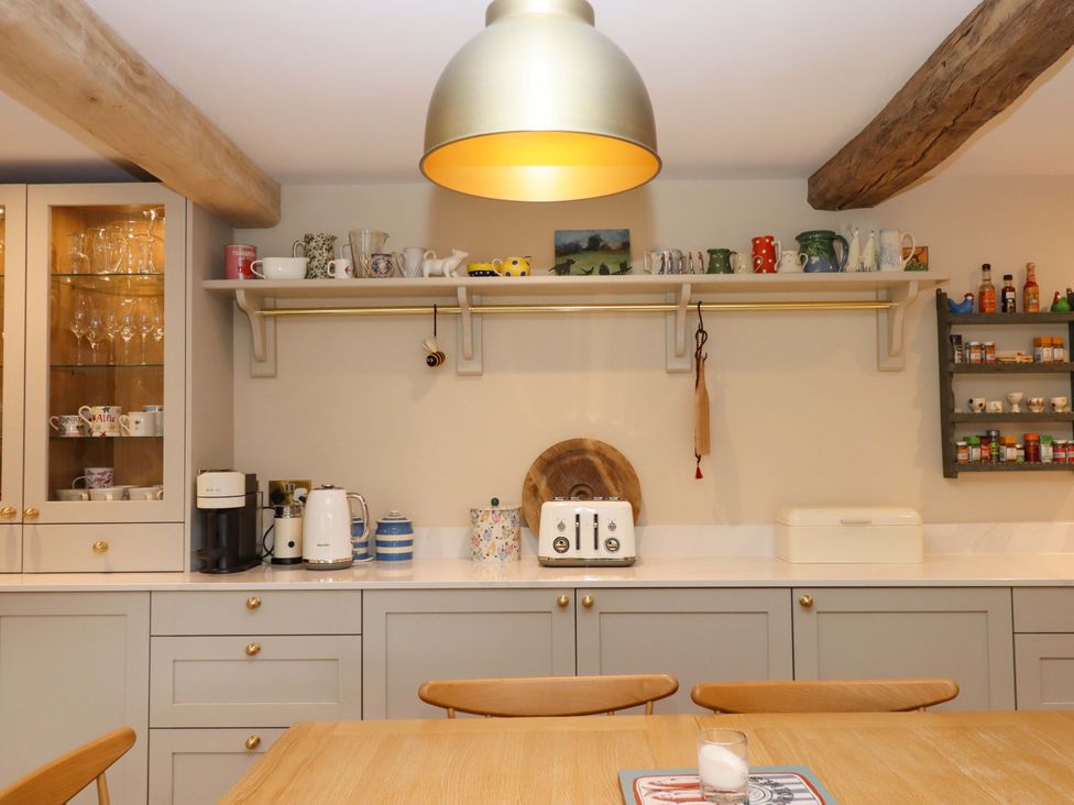 A kitchen with appliances and dishware at Town Farm Cottage Barnstaple