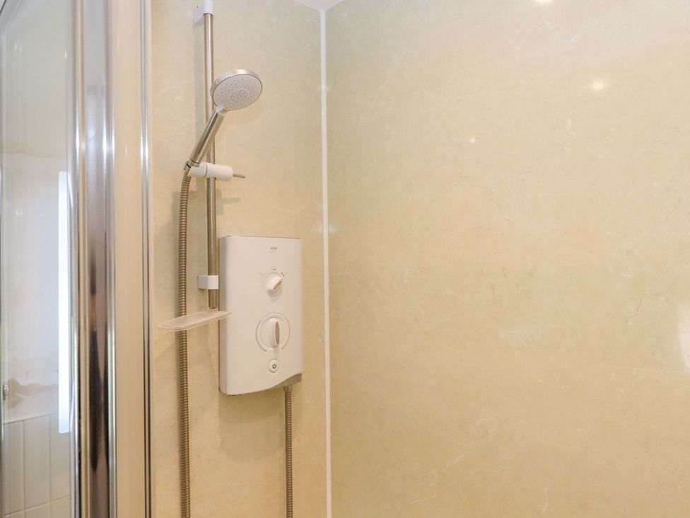 A shower with a shower head and control at Town Farm Cottage Barnstaple