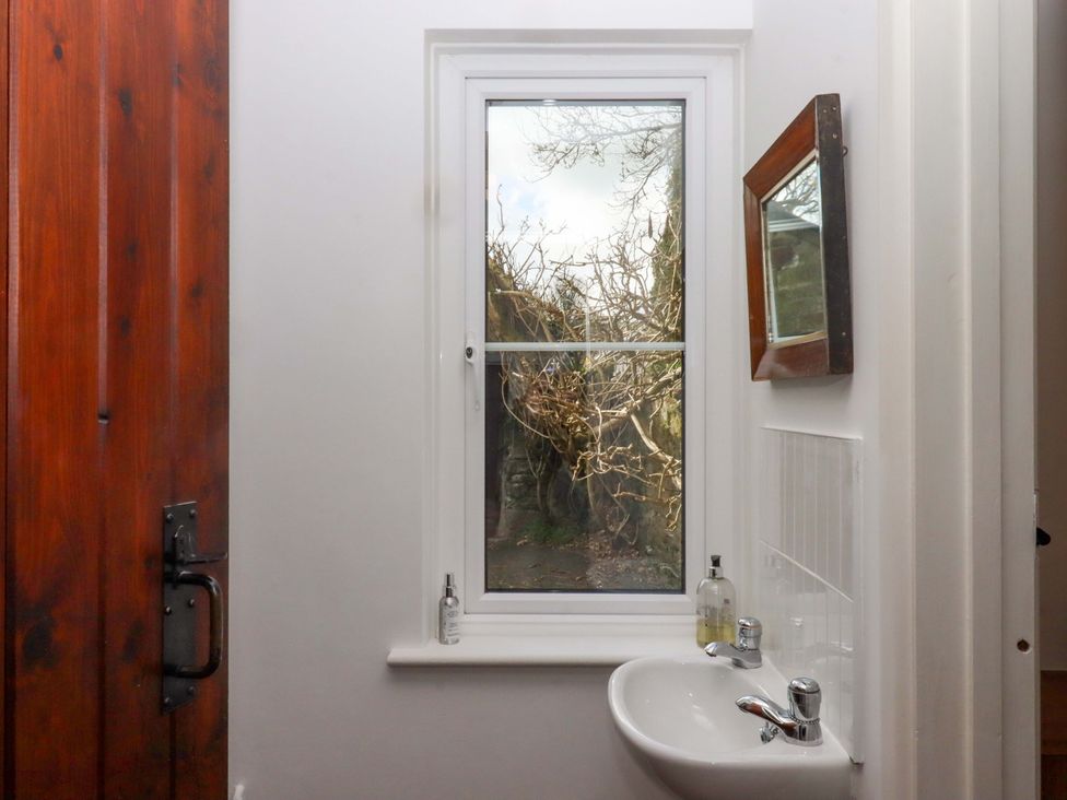 A bathroom with a sink and a window at Town Farm Cottage Barnstaple