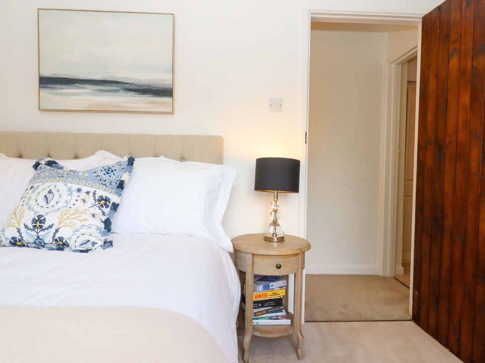 A bedroom with a bed and nightstand at Town Farm Cottage Barnstaple