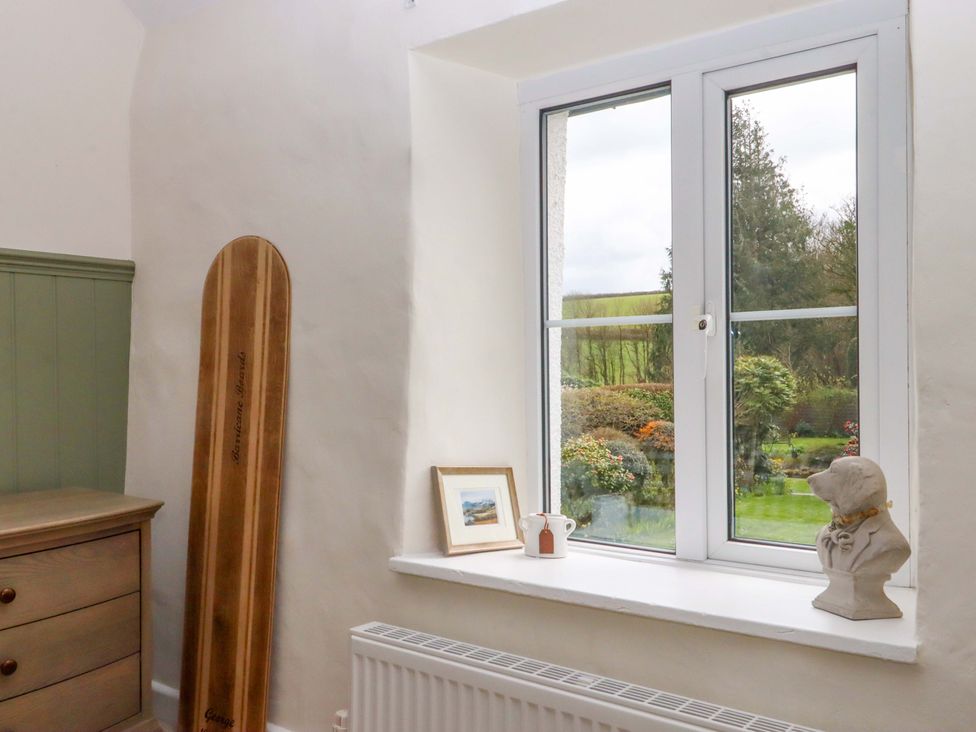A room with a window and a dresser at Town Farm Cottage in Barnstaple