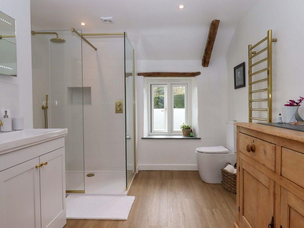 A bathroom with a shower and vanity unit at Town Farm Cottage in Barnstaple