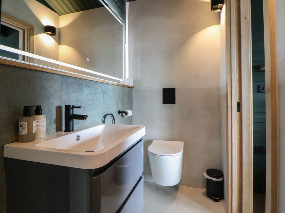 A bathroom with a sink and toilet at The Larch House in Farndon