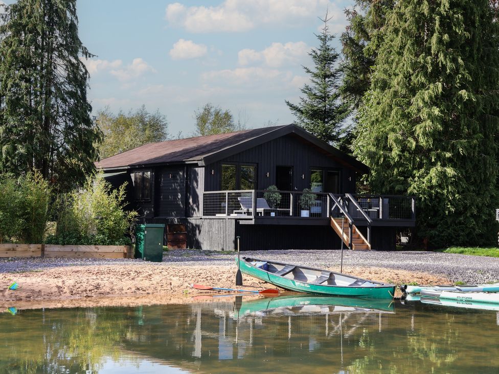 A house with a deck and kayaks at The Larch House in Farndon