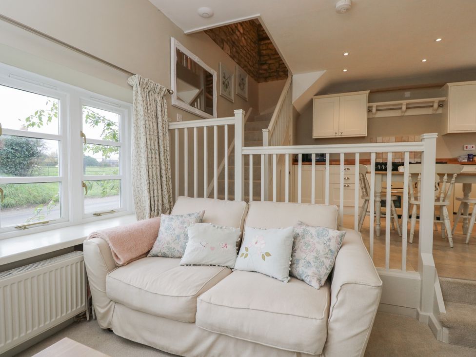 A living room with a sofa and window at Granary Cottage