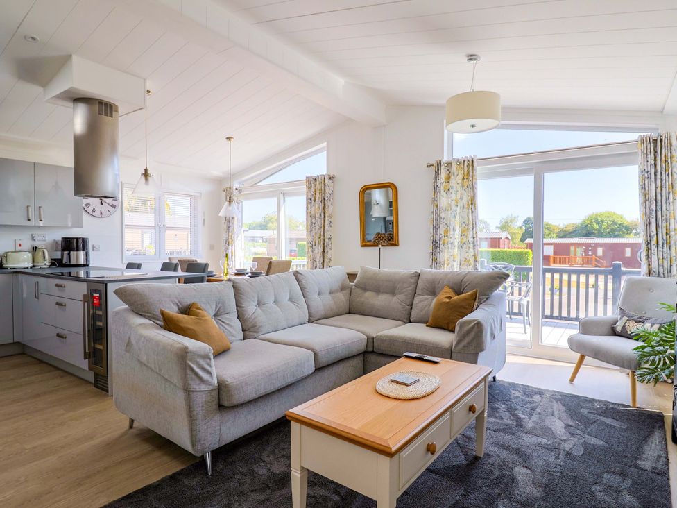 A living room with a sofa and coffee table at Cedar 1 in Pinewood Retreat in Rousdon near Lyme Regis