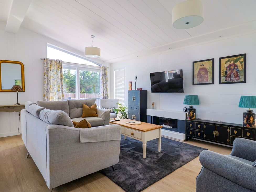 A living room with a sofa and coffee table at Cedar 1 Pinewood Retreat in Rousdon near Lyme Regis