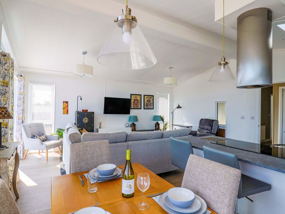 A living room with a sofa and dining table at Cedar 1 Pinewood Retreat in Rousdon near Lyme Regis