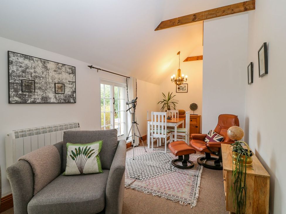 A living room with chairs and a dining table at Baywatch (St. David's View) Lynton