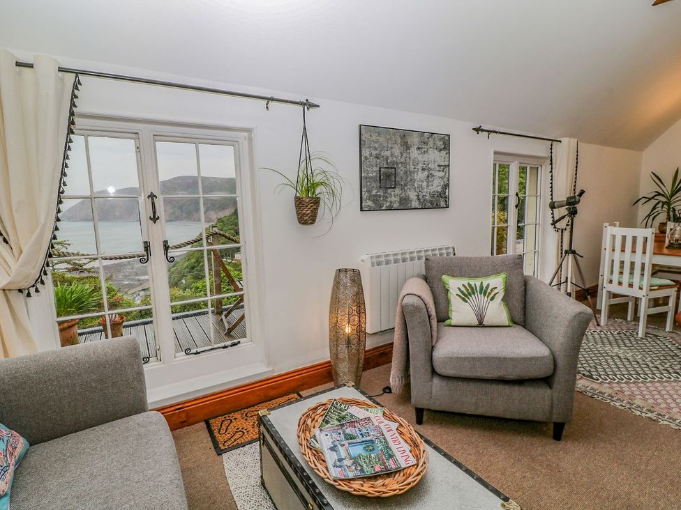 A living room with a sofa and armchair at Baywatch (St. David's View) in Lynton