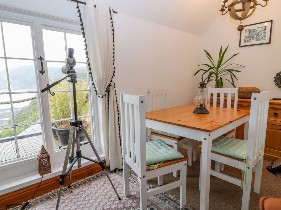 A dining room with a table and chairs at Baywatch (St. David's View) Lynton