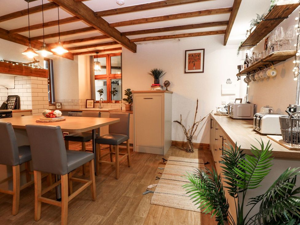 A kitchen with a dining table and chairs at Baywatch (St. David's View) Lynton