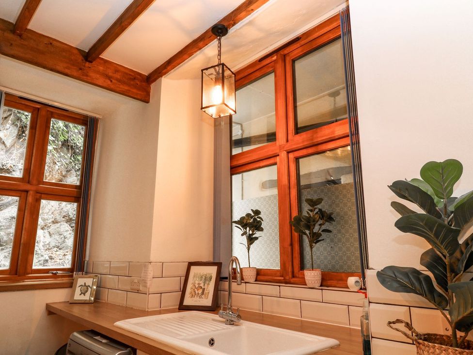 A kitchen with a sink and windows at Baywatch (St. David's View) Lynton