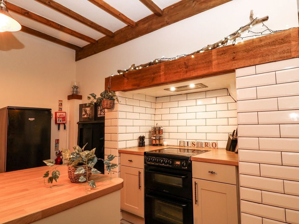 A kitchen with fridge, oven, and counter at Baywatch (St. David's View) Lynton
