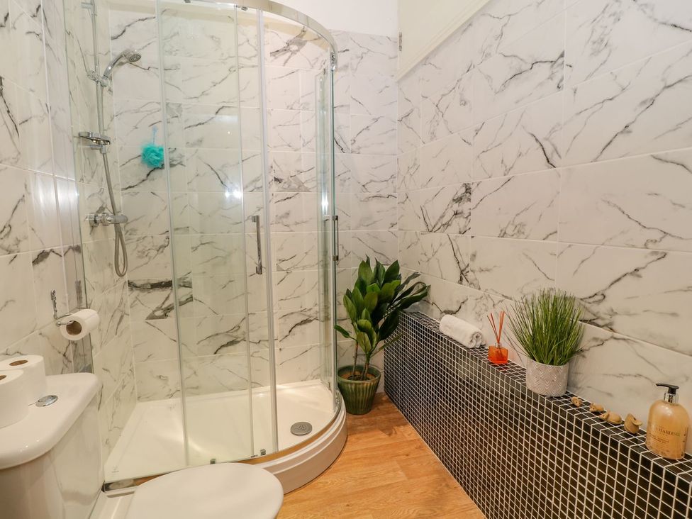 A bathroom with a shower, toilet, and sink at Baywatch (St. David's View) Lynton